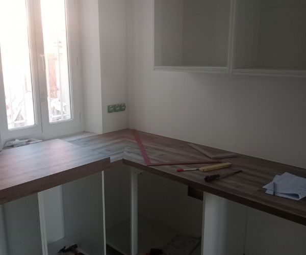 Détail de la pose des plans de travail bois dans une cuisine en rénovation – NATB