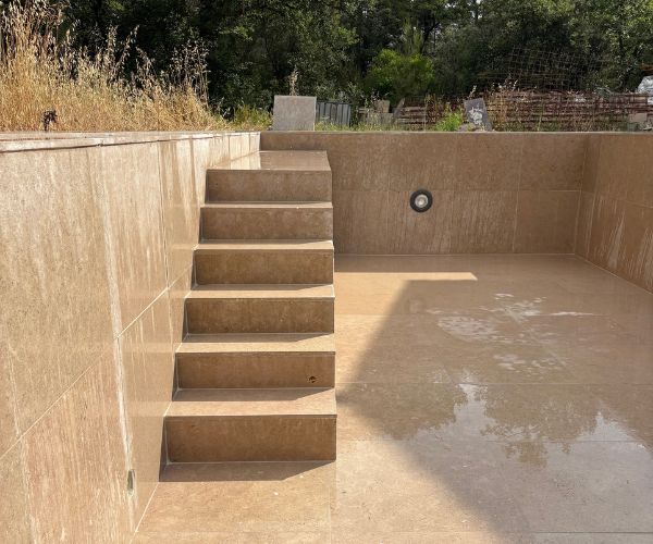 Escalier intégré en pierre dans piscine